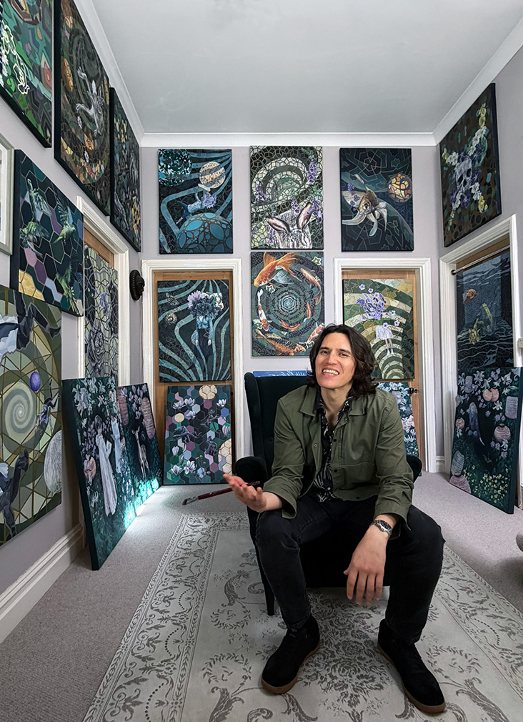 Chris Berry surrounded by his paintings